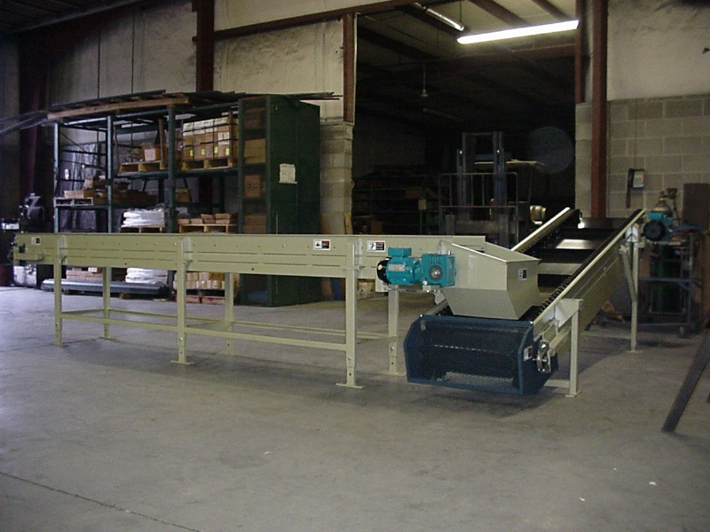 Shredder discharge belt conveyor with discharge chute & box feed conveyor with adjustable discharge height.