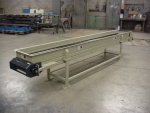 Shredder discharge belt conveyor with magnetic head pulley and takeoff rail.
