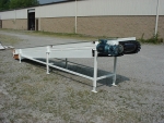 Shredder discharge belt conveyor with magnetic head pulley, takeoff rail and cleated, sidewall belt.